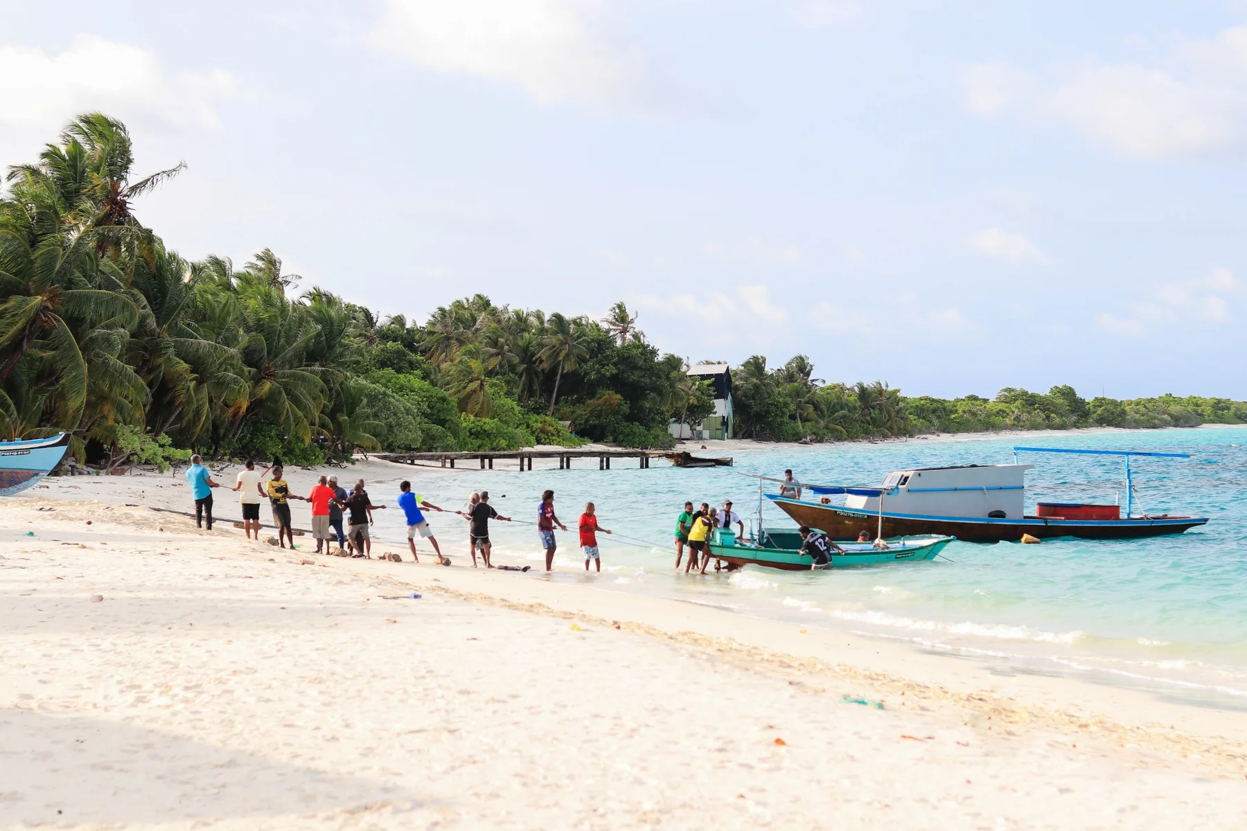 Local community moving a fishing boat
